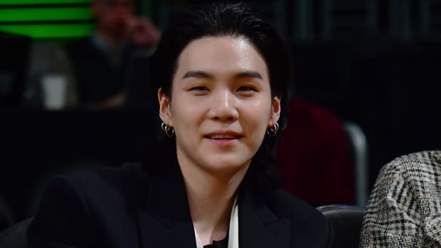 Suga smiles for a picture.